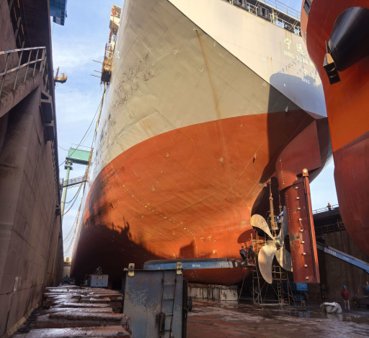 Target container ship in dry dock showing hull and propeller